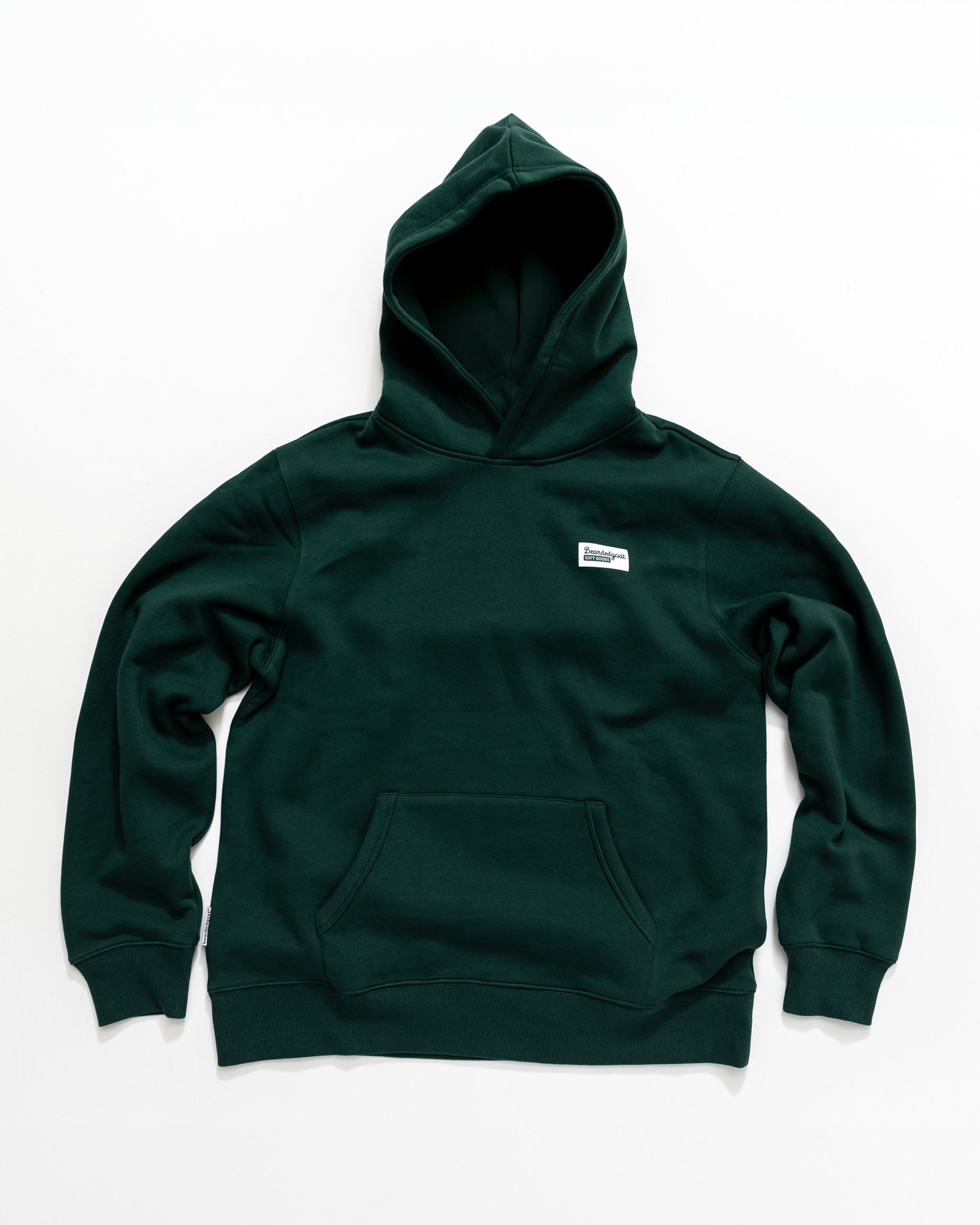 The beardedgoat Men's Void Hoodie in dark green features a front pocket and a small rectangular white chest label, shown laid flat on a white background.