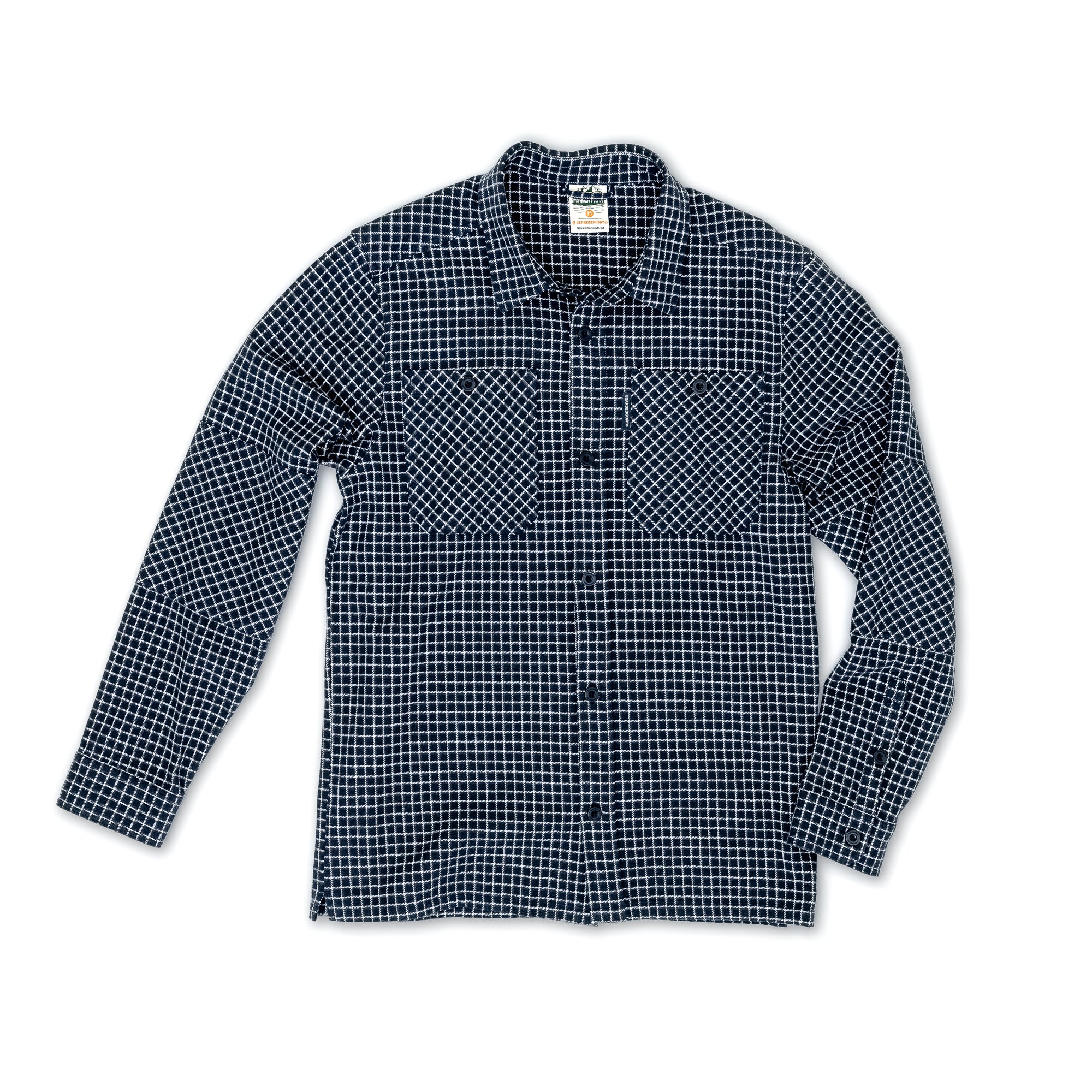The beardedgoat Mens Ozark Utility Flannel is a classic fit, heavyweight cotton flannel button-up in dark blue and white grid checks with two chest pockets, shown laid flat on a white background.