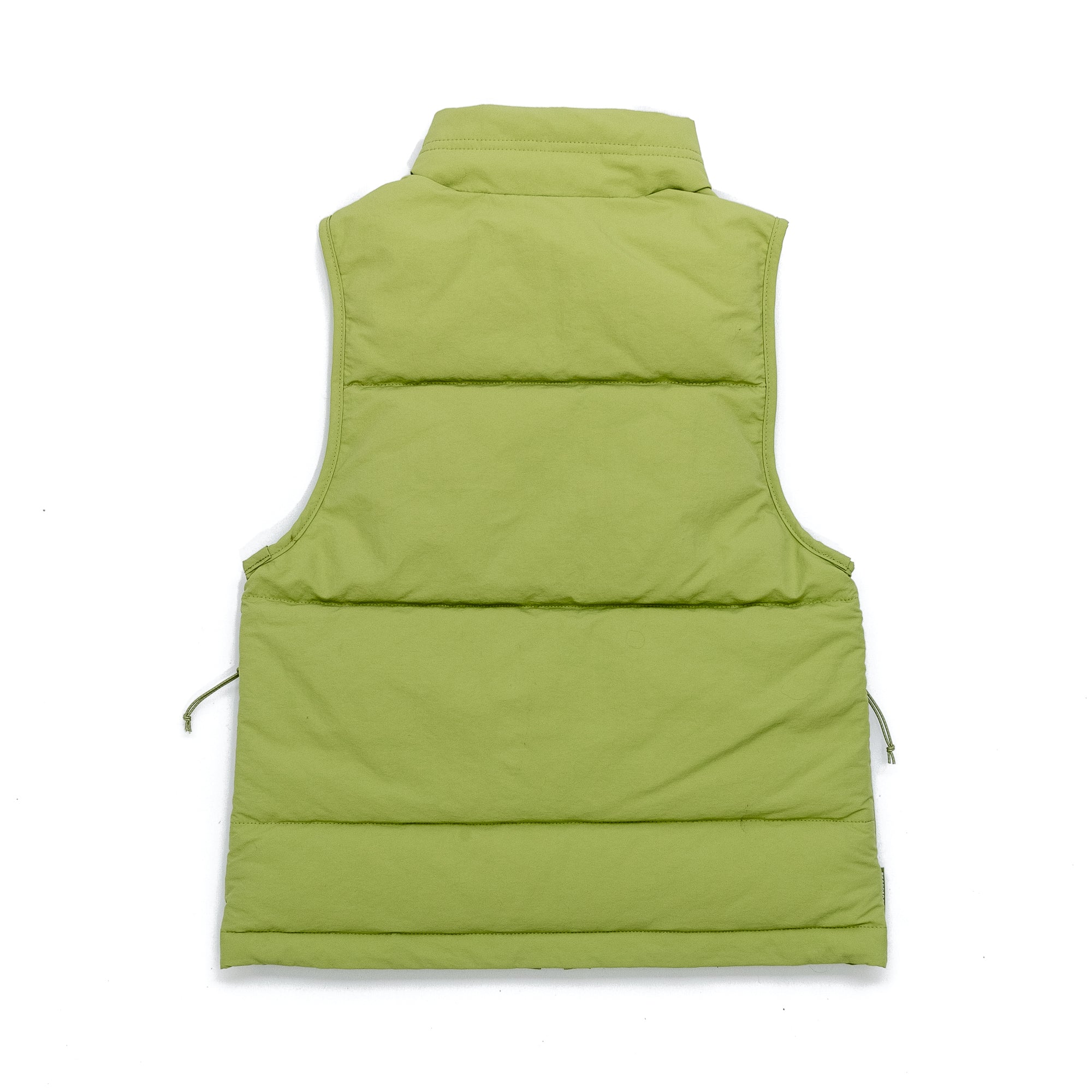 The BEARDEDGOAT Womens Wallowa Puffer Vest - LE in light green is shown from the back, highlighting its horizontal stitching, synthetic down insulation, high collar, and water-repellent finish against a white background.