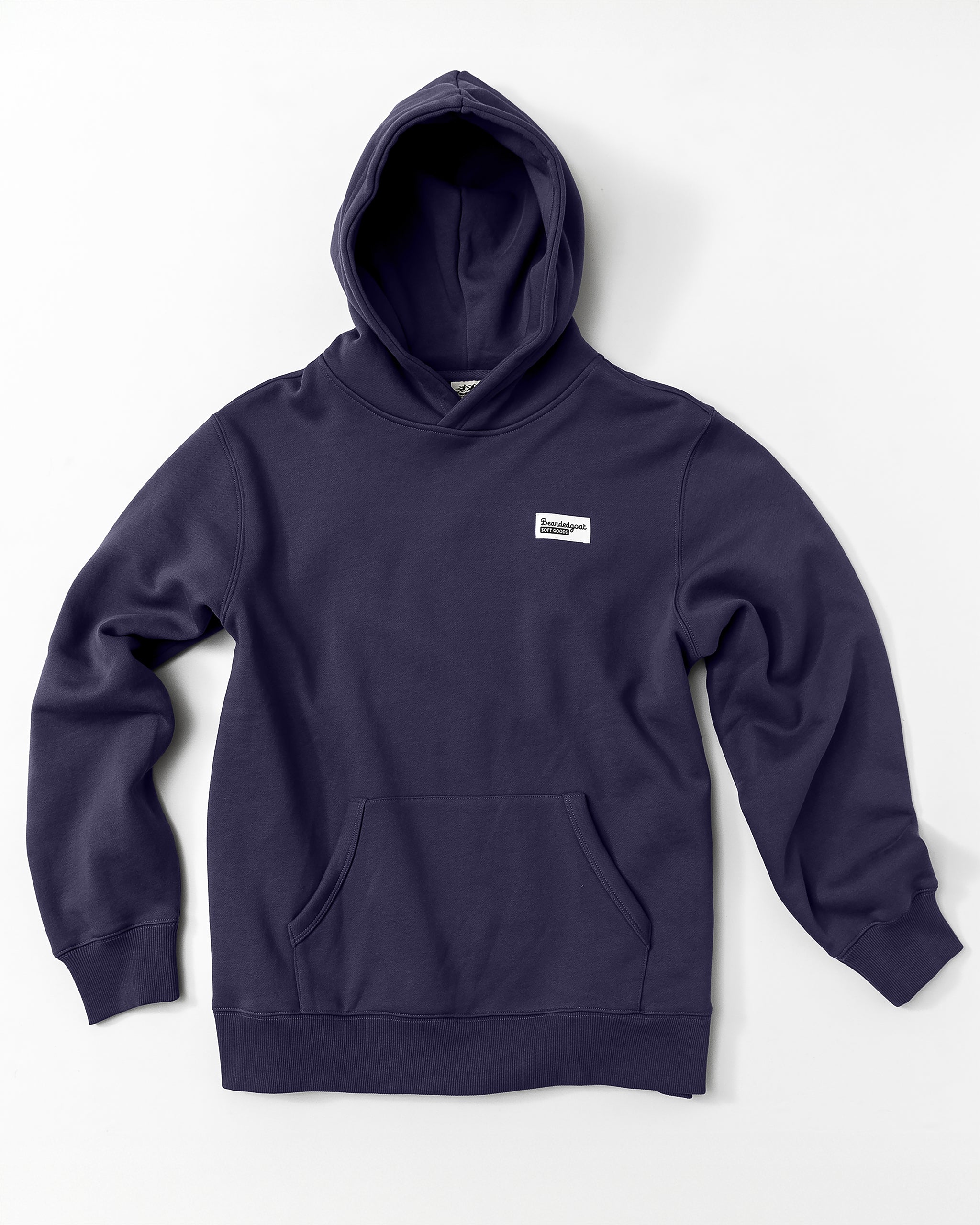 The beardedgoat Men's Void Hoodie in navy blue is made from heavyweight cotton fleece, features a front pocket and a small white rectangular patch on the left chest, and is displayed on a white background.
