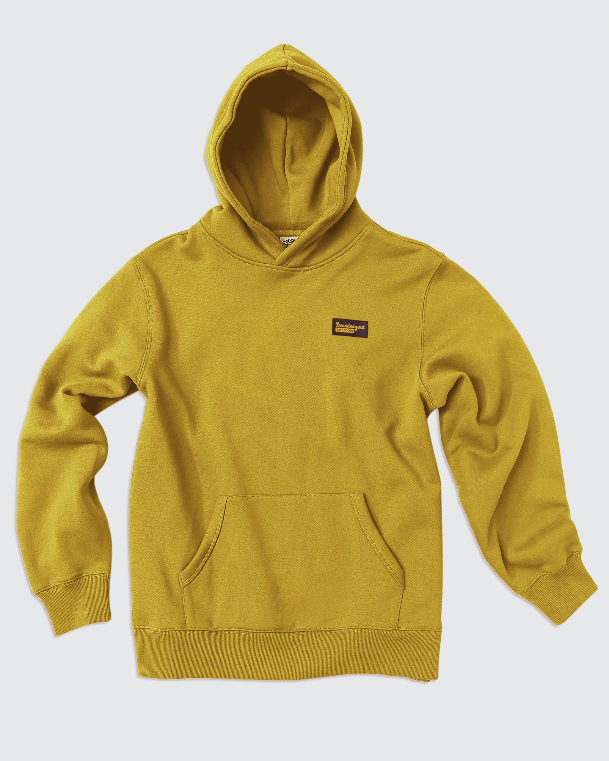 The VOID™ Hoodie by beardedgoat is a men's mustard yellow heavyweight cotton fleece hoodie with a hood, front pocket, and small rectangular patch on the left chest, shown on a plain white background.