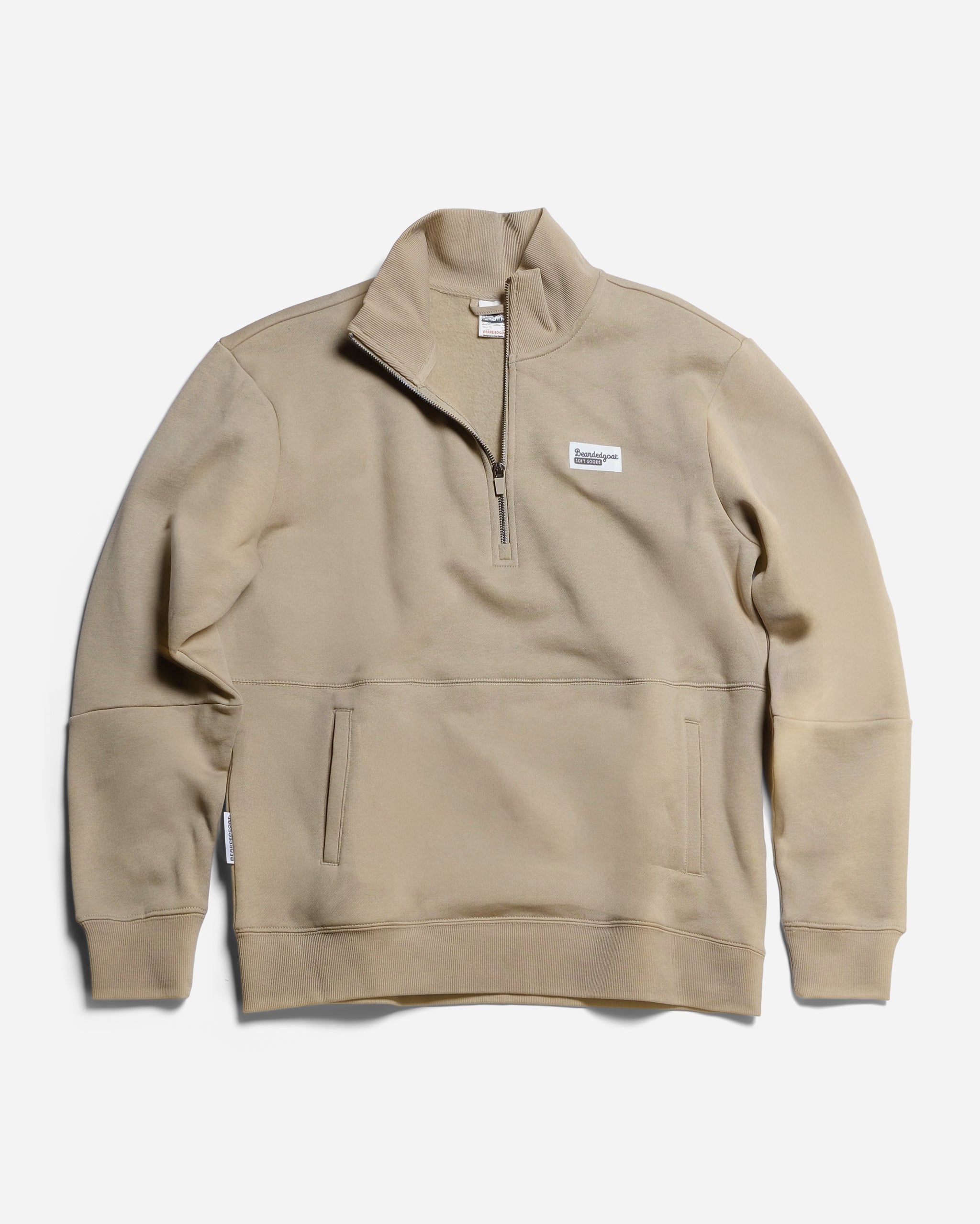 The BEARDEDGOAT NEW — VOID™ Half Zip in Terra Sienna is a premium cotton fleece pullover with a high collar, front half-zip, side pockets, and a small rectangular logo patch on the left chest, shown laid flat on a white background.