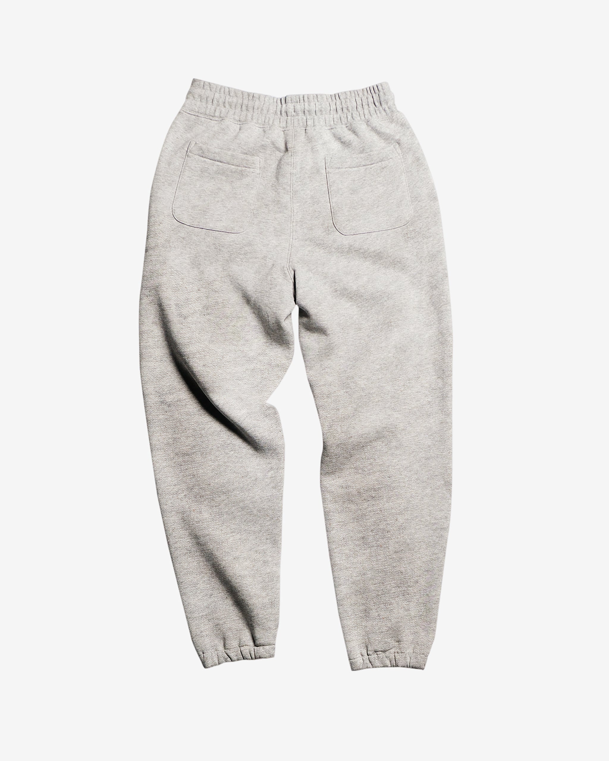 The BEARDEDGOAT Women’s Overnight™ Classic Jogger in light gray is displayed flat on a white background, featuring a high-rise waistband, two square back pockets, heavyweight cotton fleece fabric, and elastic ankle cuffs.