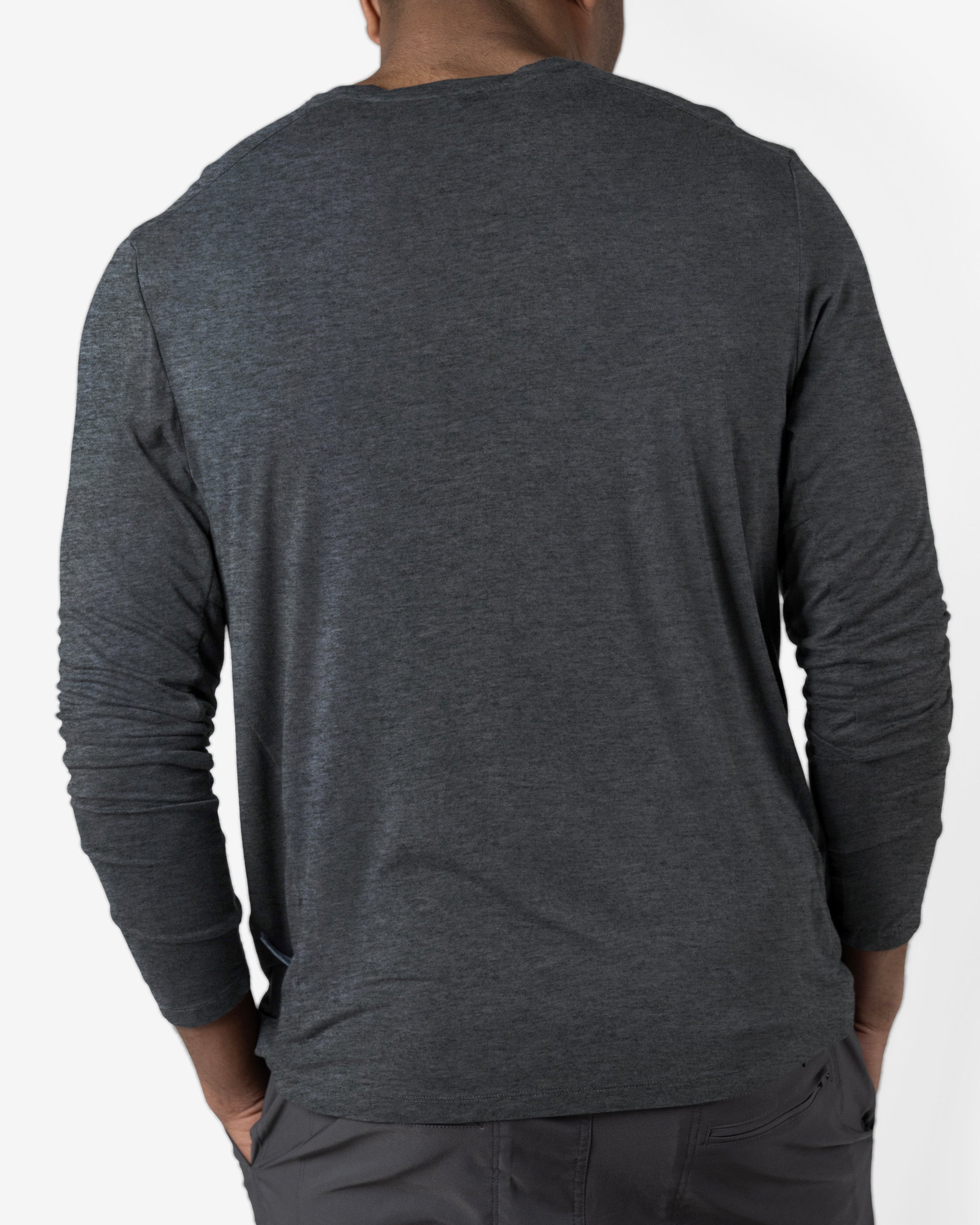 A person is shown from the back wearing a BEARDEDGOAT Men’s EverZen™ Long Sleeve in dark gray and gray pants against a plain white background.