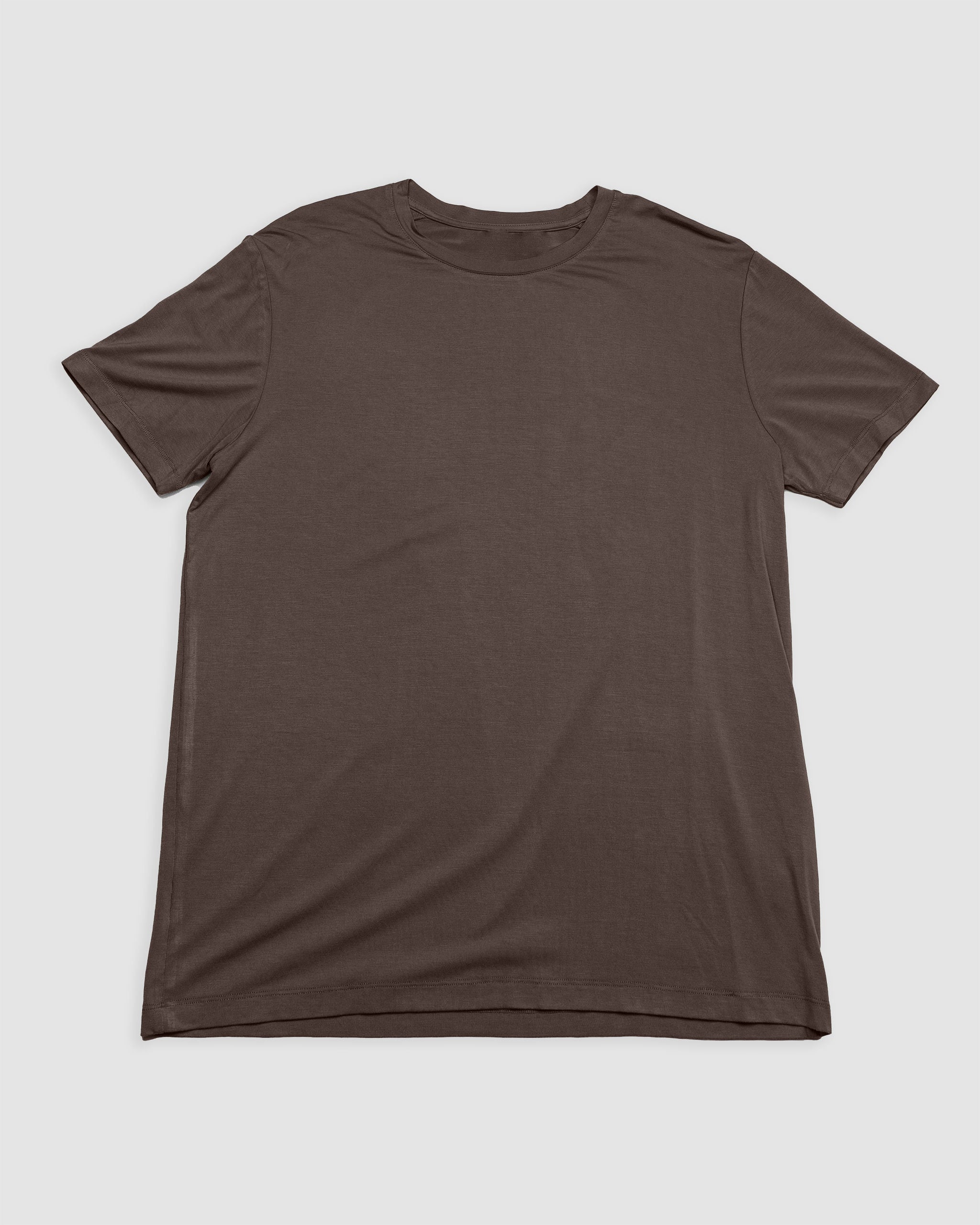 The BEARDEDGOAT Men’s EverZen™ Short Sleeve in Dark Earth is laid flat on a light gray surface, showcasing its crew neck and comfortable design for men.