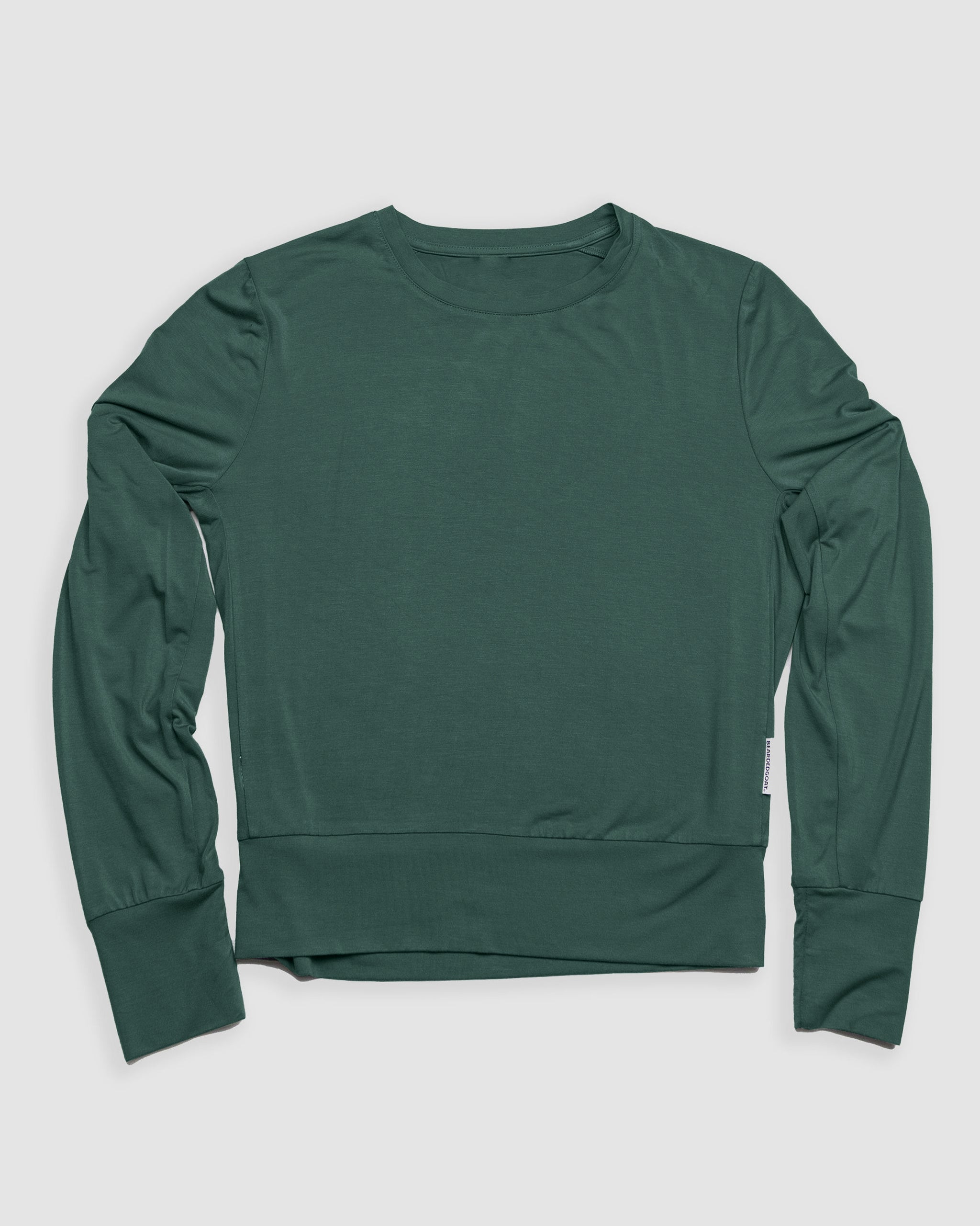 The BEARDEDGOAT Women’s EverZen™ Bamboo Long Sleeve is a forest green, relaxed-fit crew neck with ribbed cuffs and hem, made from an eco-friendly bamboo blend, shown laid flat on a white background.