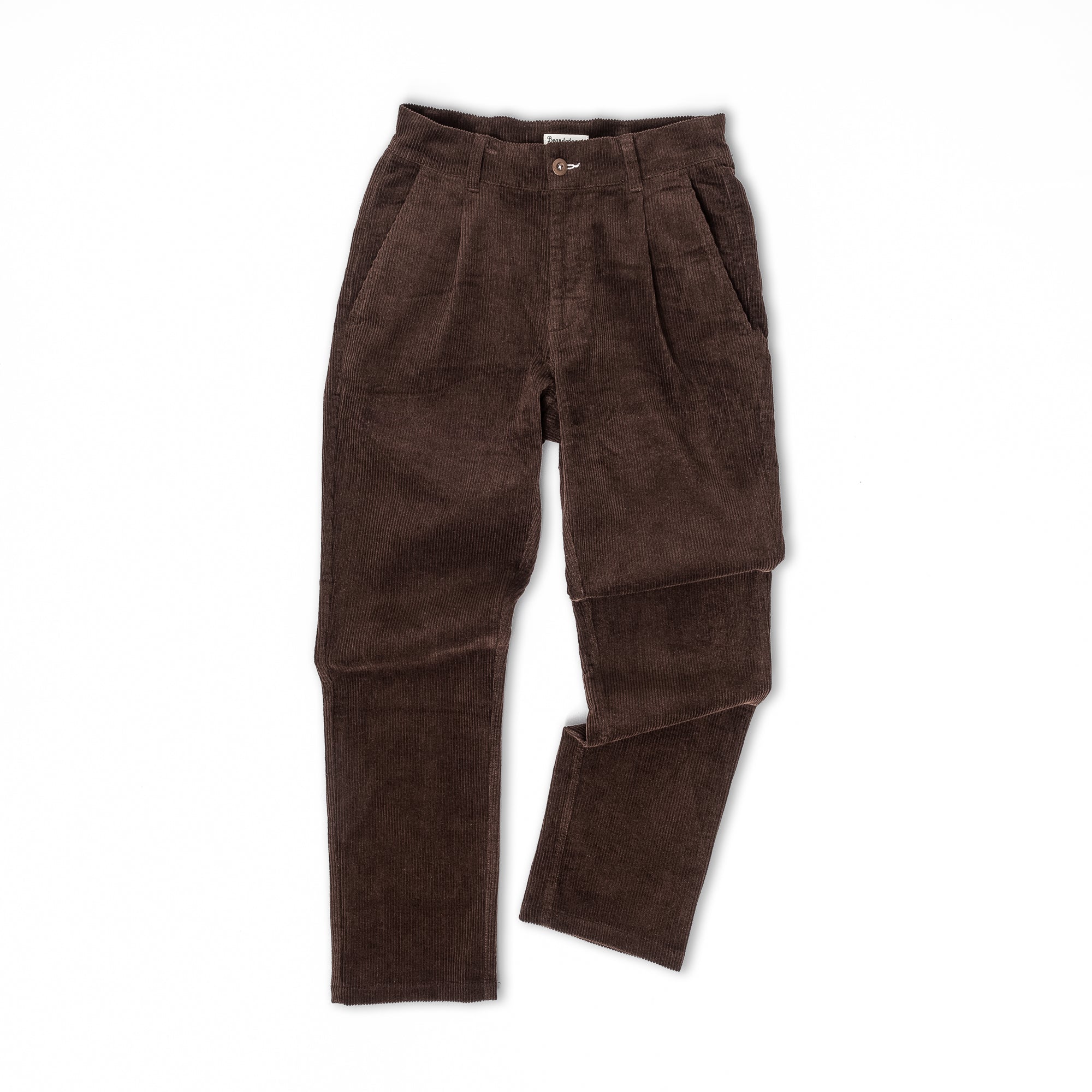 A pair of beardedgoat Mens Moor Corduroy Pants in dark brown with a loose fit, front pleats, and side pockets is laid flat on a white background.