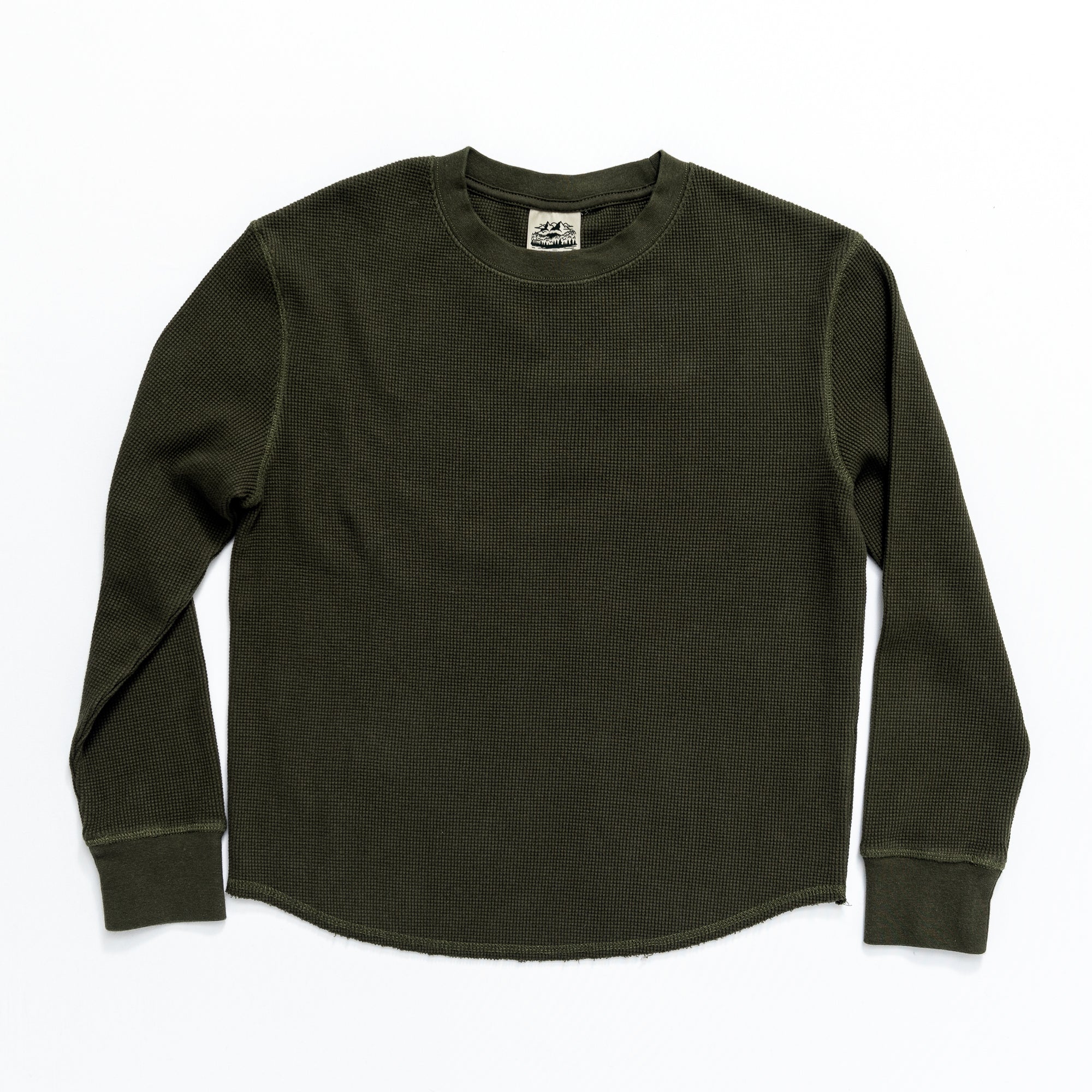 The BEARDEDGOAT Womens Wakeside Waffle is a dark green, long-sleeve cotton shirt with ribbed cuffs and a crew neck for vintage style, shown laid flat on a white background.
