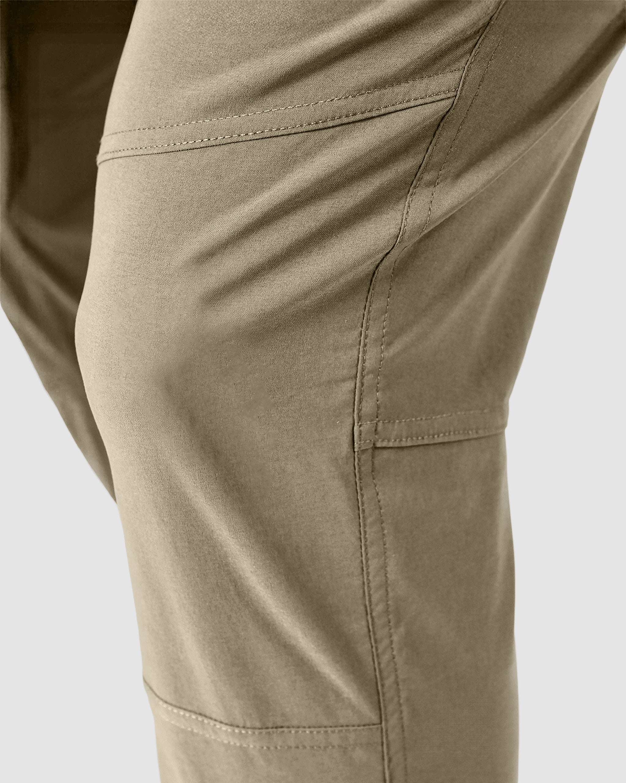 Close-up of BEARDEDGOAT’s NEW—ROVER™ Pant in khaki, showing the side seam, pocket stitching, and details of the thigh and knee against a plain background.
