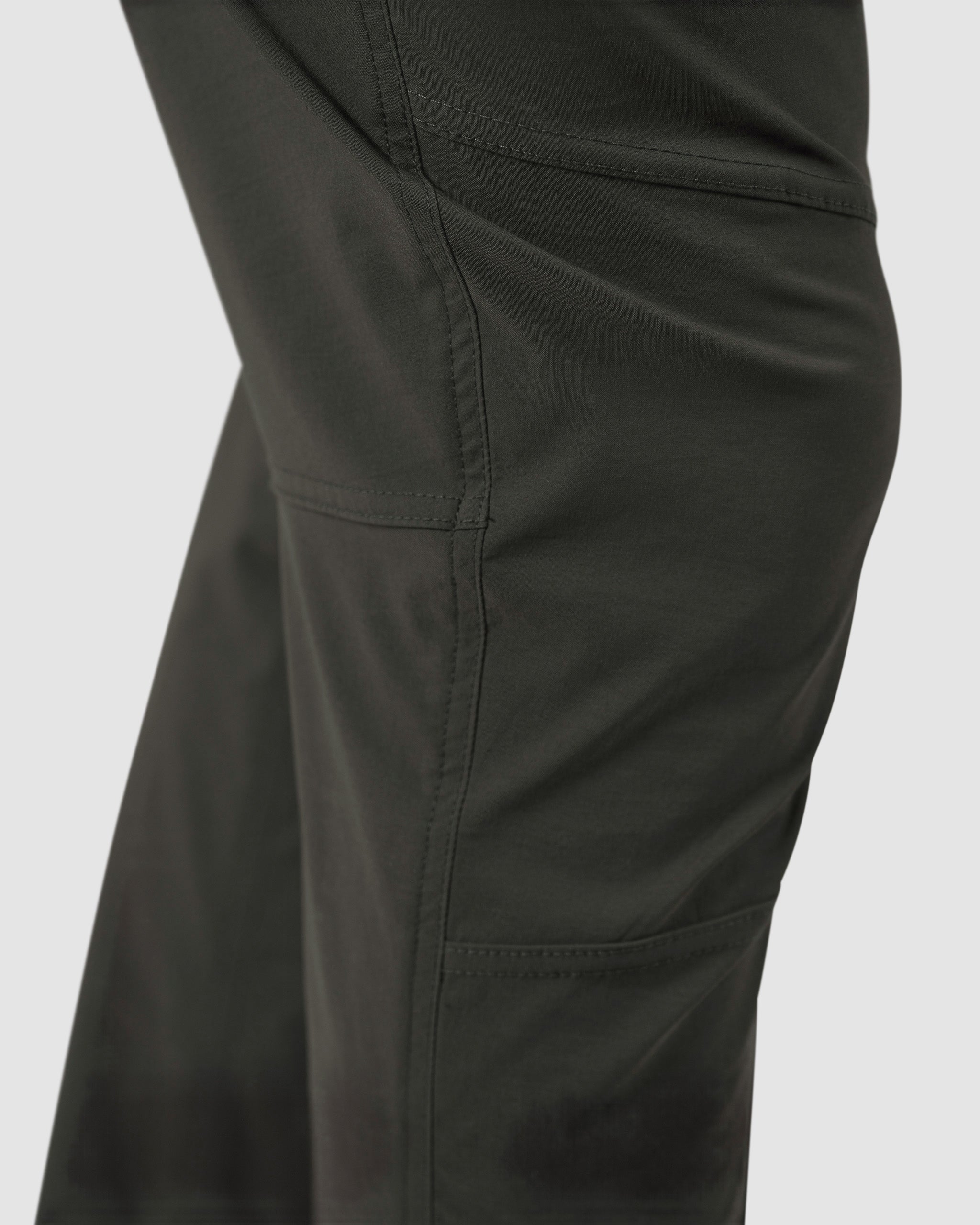 Close-up of the side seam and pocket on BEARDEDGOAT’s NEW-—ROVER™ Pant in dark green performance stretch nylon, highlighting detailed stitching and fabric texture.