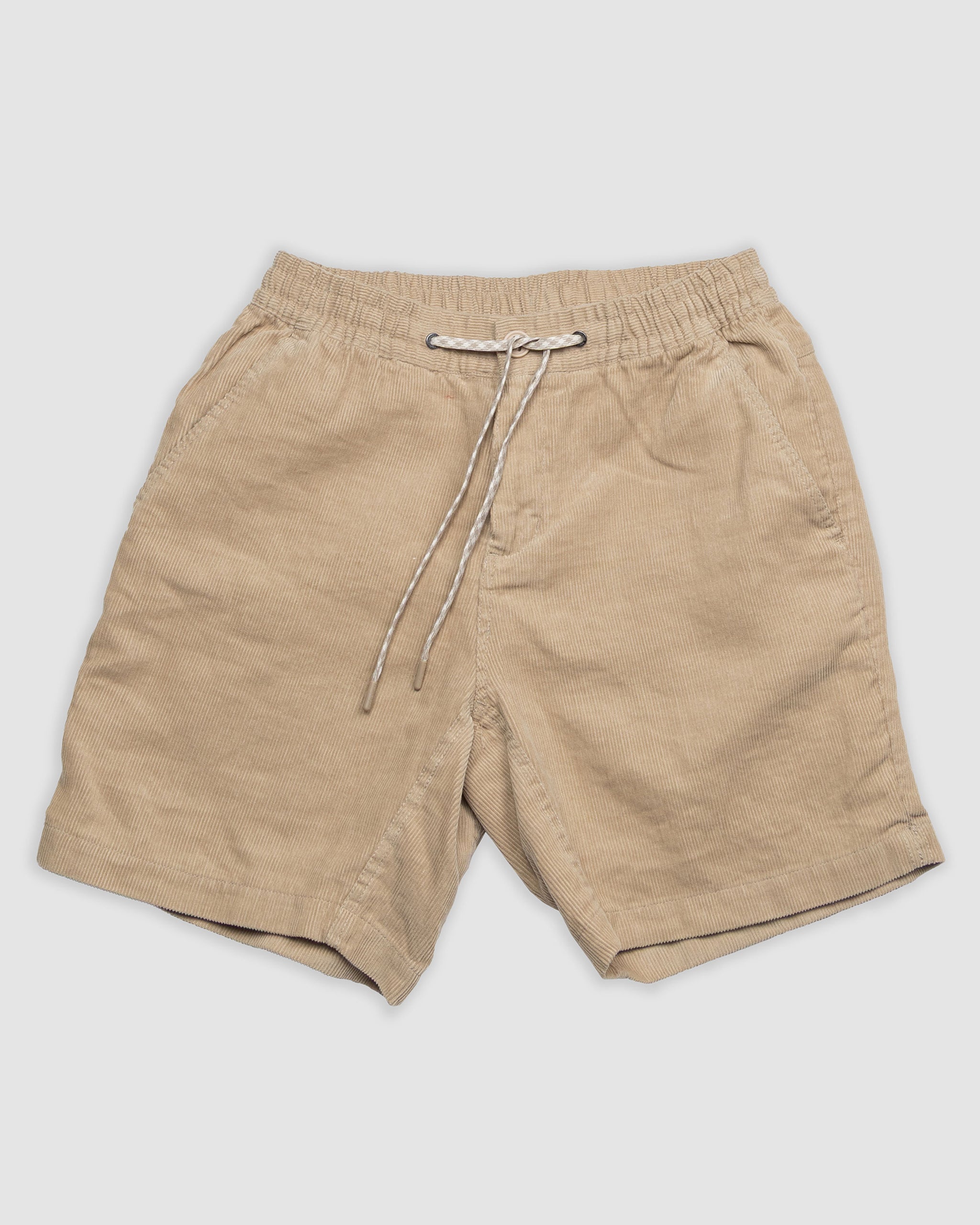 The BEARDEDGOAT Men's Cord Short features beige corduroy, an elastic waistband with a white drawstring, and side pockets—perfect for everyday versatility.