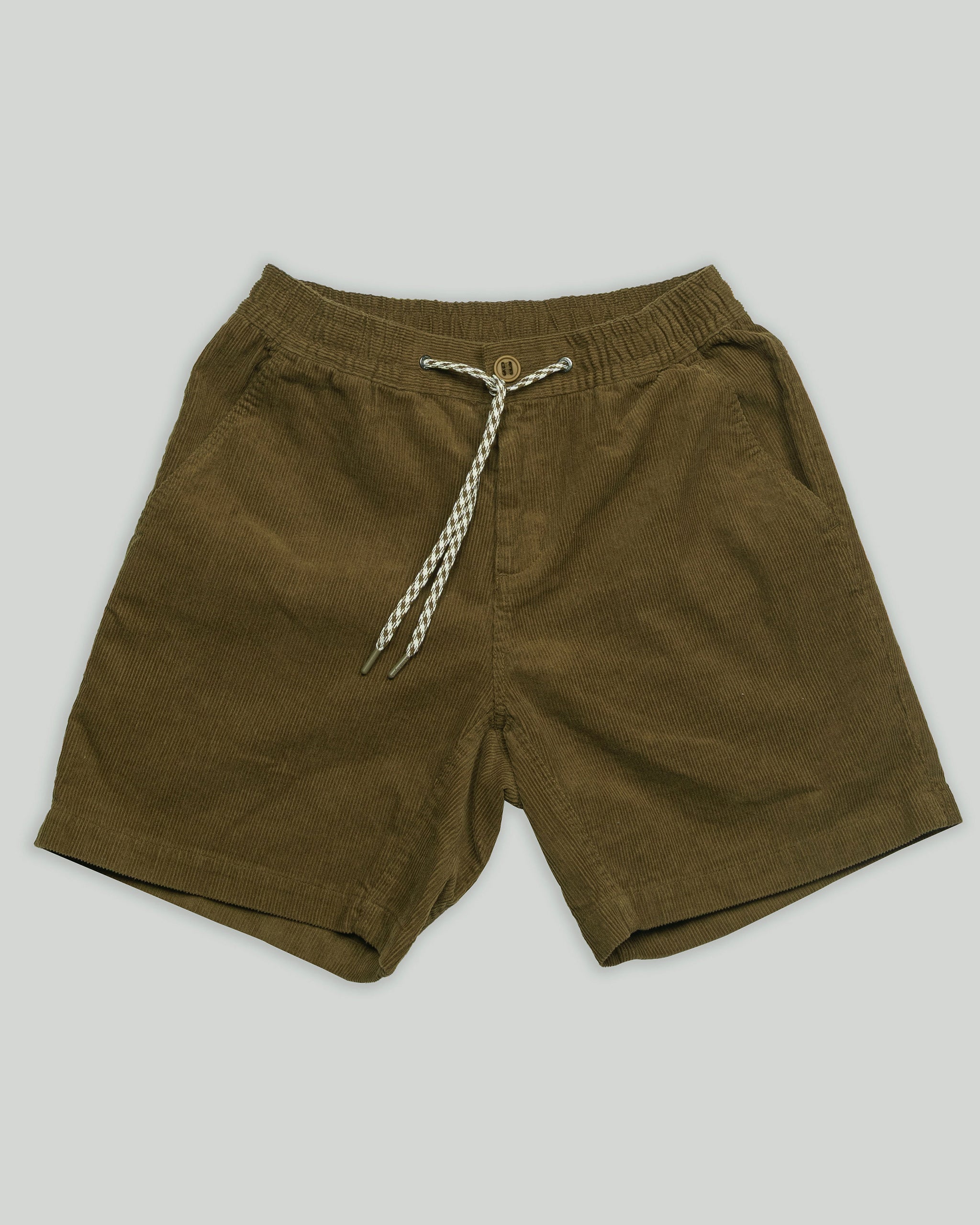 The BEARDEDGOAT Men's Cord Short features brown corduroy, an elastic waistband, and a white-and-black braided drawstring—combining vintage style with versatile comfort. Displayed flat on a light grey background.