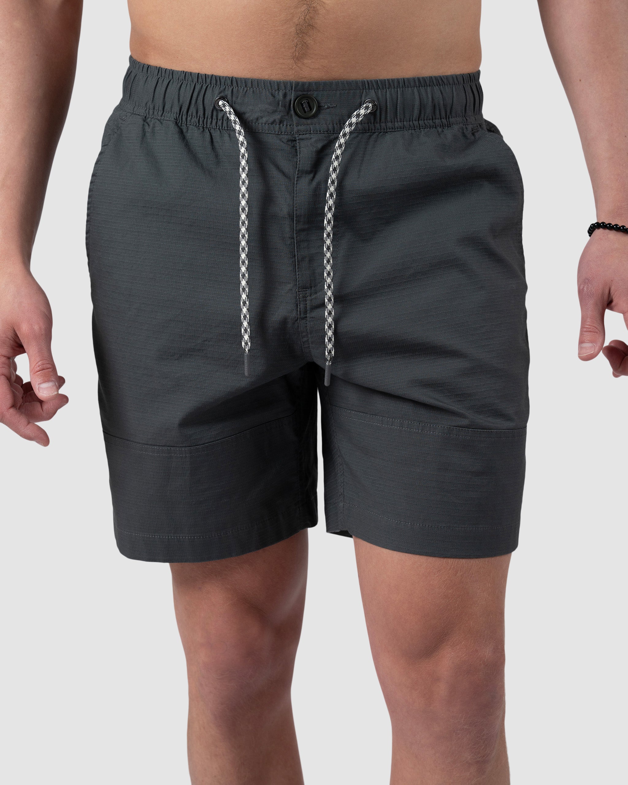 A person models the BEARDEDGOAT Mens Canopy Short, crafted from stretch cotton ripstop, against a plain light background with arms relaxed and only the torso and legs shown.