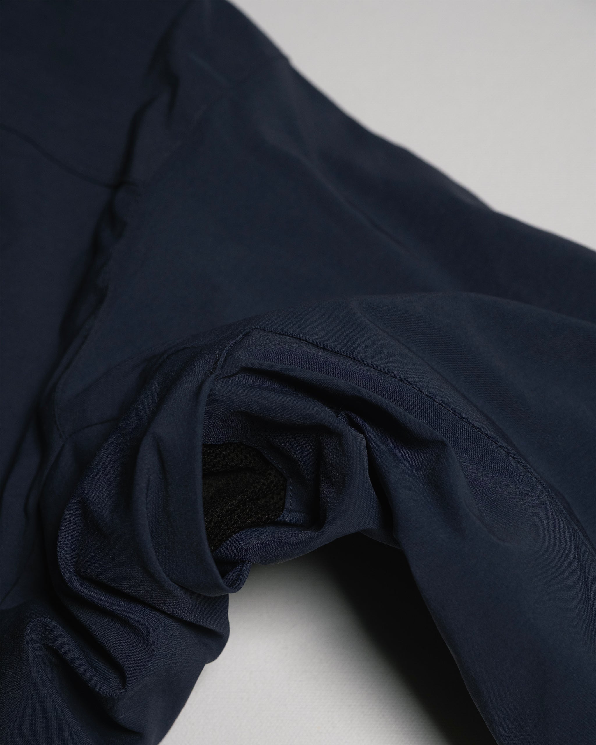 A close-up of the NEW — OSLO Rover™ Performance All-Season Jacket by beardedgoat shows the navy sleeve and cuff, turned inside out to reveal its black lining—emphasizing this versatile, all-season design.