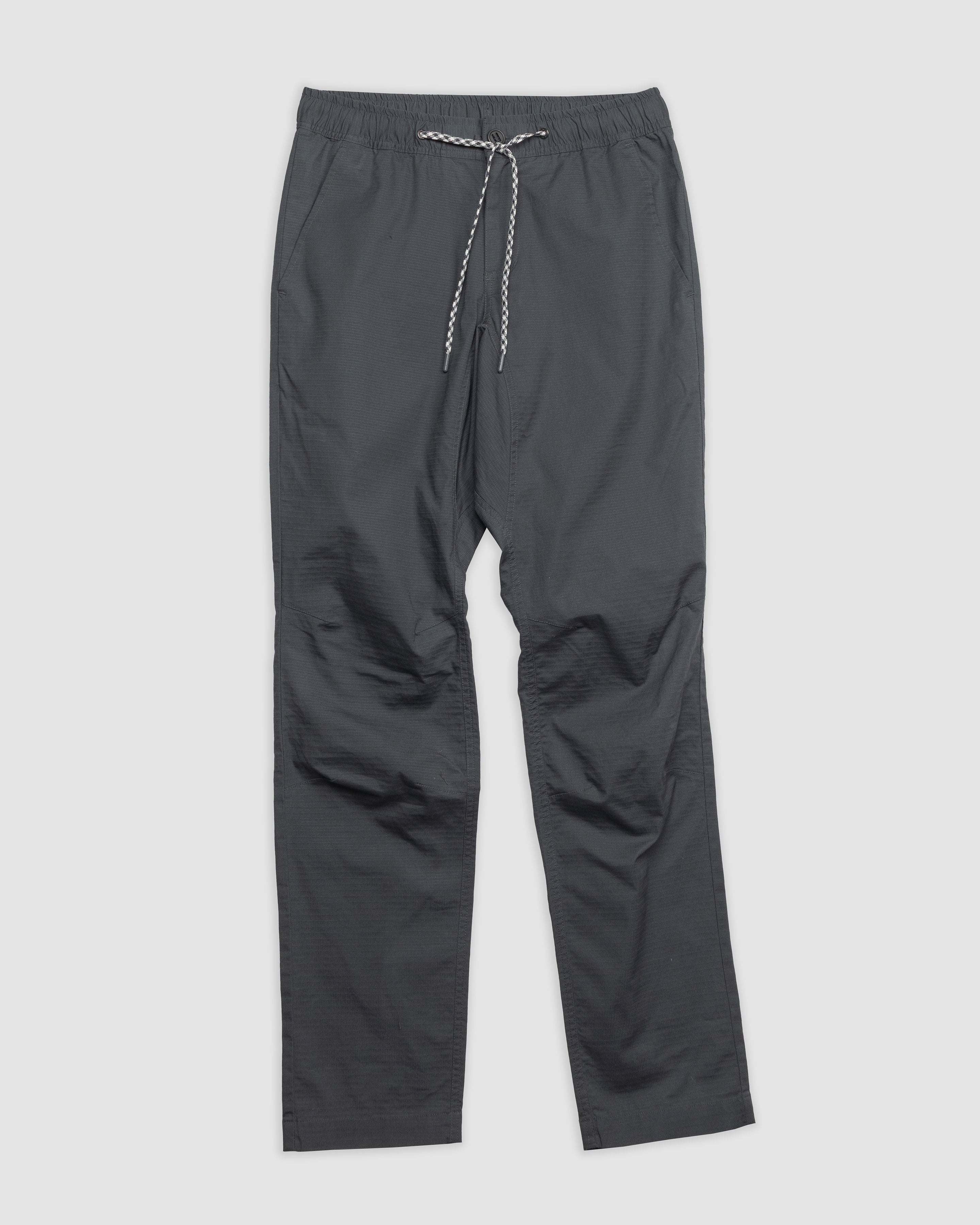 The BEARDEDGOAT Men's Canopy Pant, shown in dark gray on a light gray background, features durable ripstop fabric, an elastic waistband, straight legs, and side pockets.