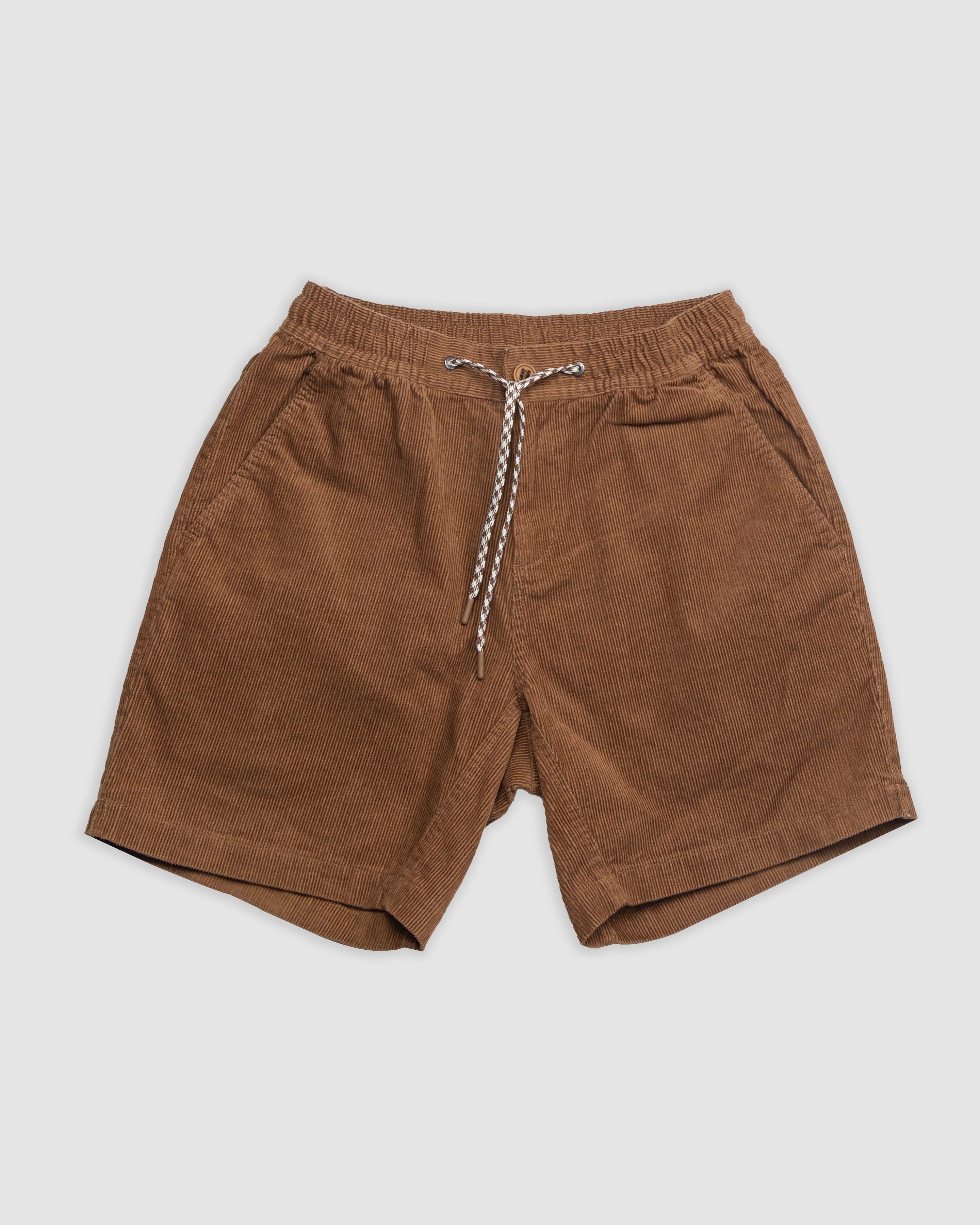BEARDEDGOAT Mens Cord Short in brown features an elastic waistband, white and black drawstring, and side pockets for everyday versatility with vintage vibes. Shown laid flat on a light gray background.
