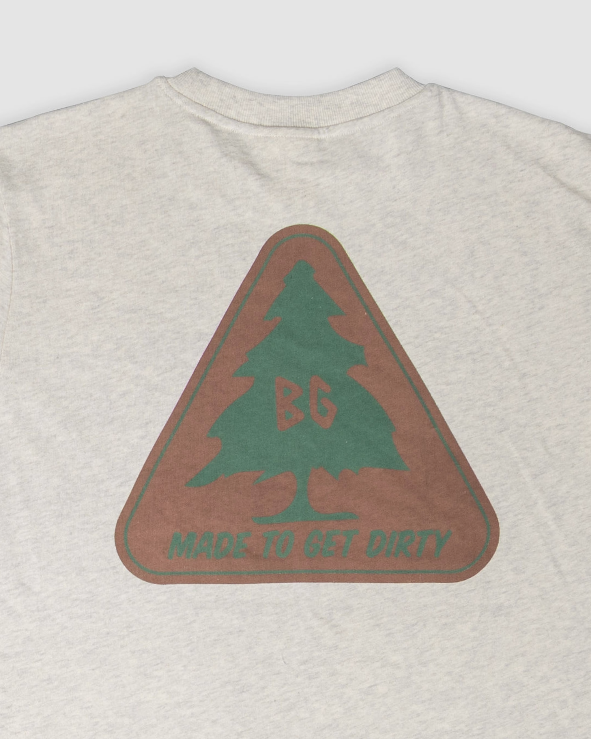 The BEARDEDGOAT Pine Tee in Snow Grey is made from thick cotton and features a triangular logo with a green pine tree, BG letters at the center, and MADE TO GET DIRTY below.