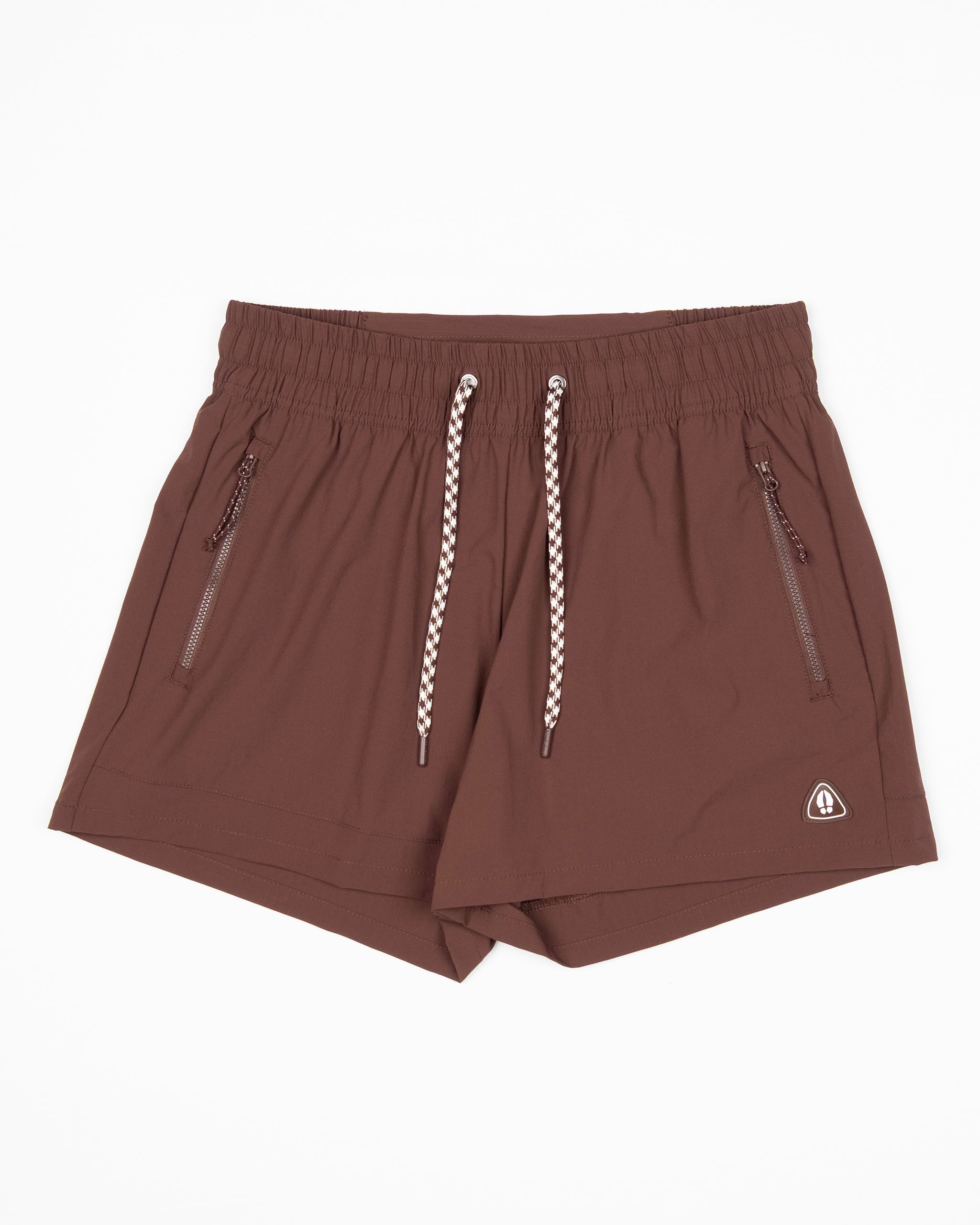 The BEARDEDGOAT Women's Alpina Short is a brown, high-waisted adventure short made from durable ripstop fabric with white and brown drawstrings, two zippered side pockets, and a small white triangular logo on the lower right side.